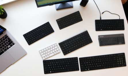 Verschiedene Bluetooth-Tastaturen für Windows-PCs auf einem Schreibtisch mit Windows-Laptop
